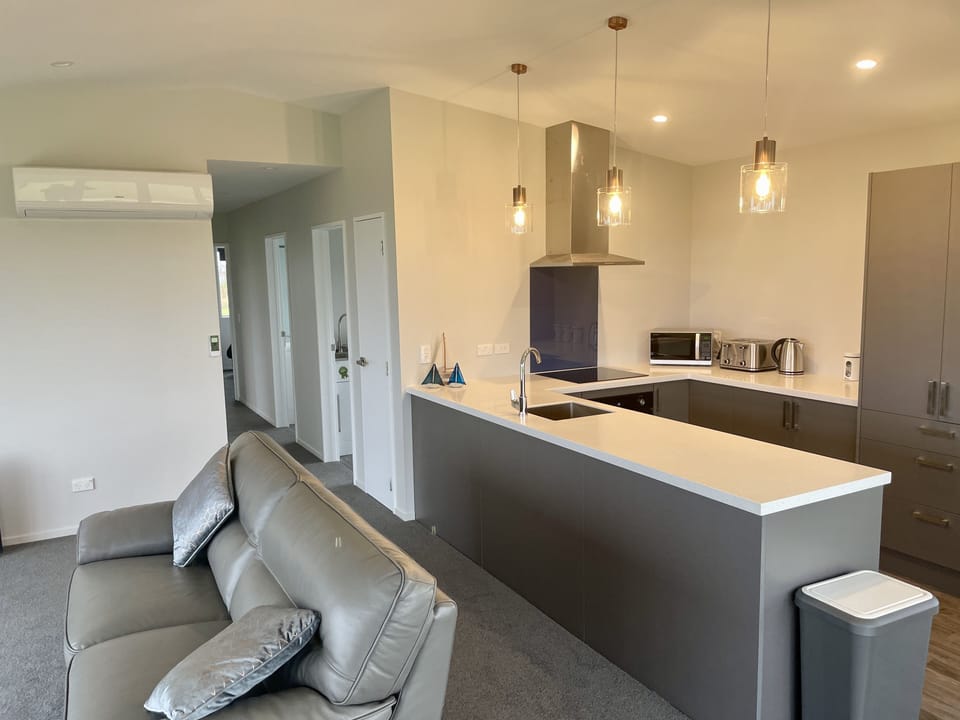 Panoramic views of the ocean close enough to the beach to hear the waves. House in Otago