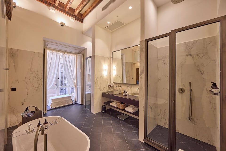 The Grand Essence - Suite Signature | Bathroom | Shower, rainfall showerhead, hair dryer, slippers