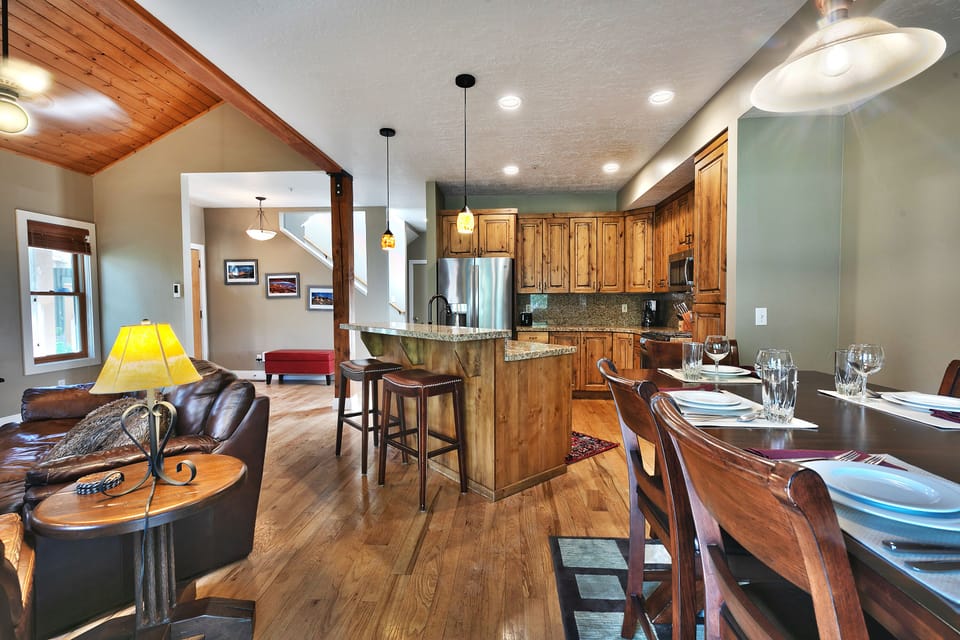 Dining, living, and kitchen area, vaulted ceilings on the main floor with hardwood floors throughout