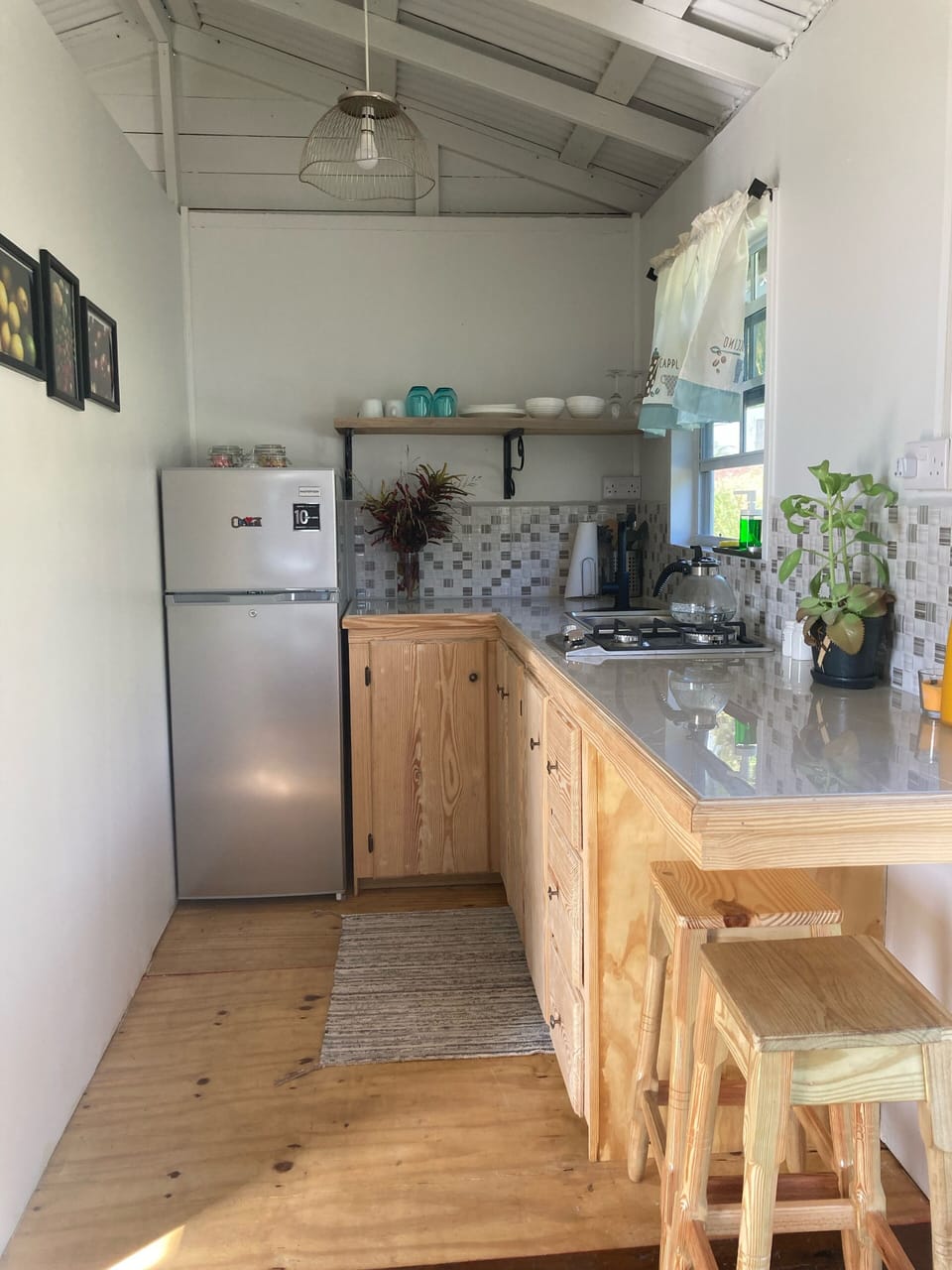 Kitchen has fridge, 2 burner stove, coffeemaker, kettle, pots & pans,  utensils 