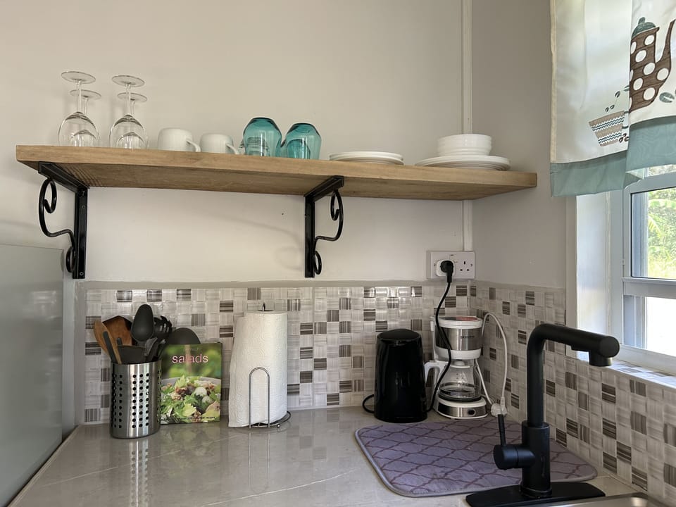 Coffee maker, electric kettle, dinnerware and kitchen utensils are all included 