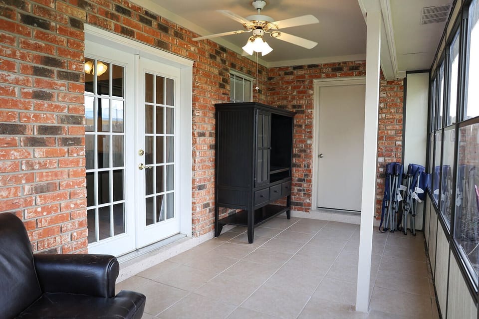 Enclosed sunroom off master bedroom.