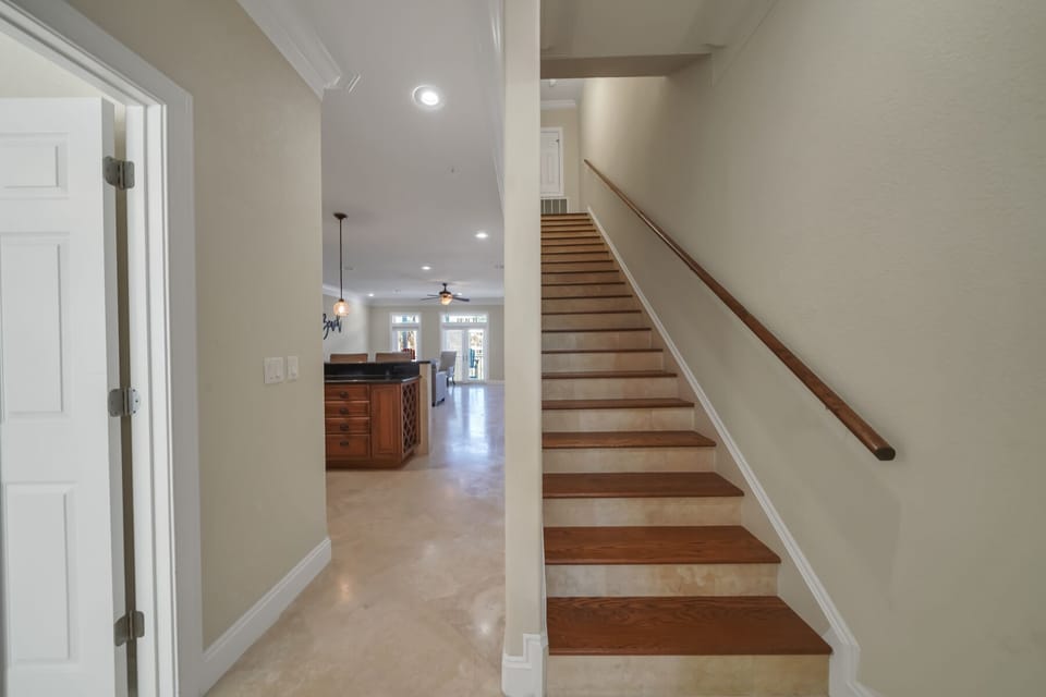 Hallway to 2nd Floor Living Area and Steps to 3rd Floor. 