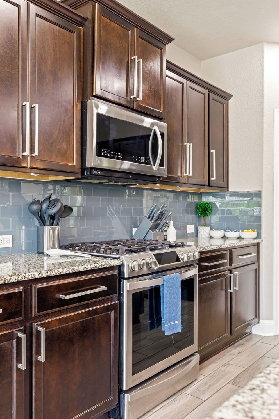 Kitchen with dark cabinets & modern appliances
