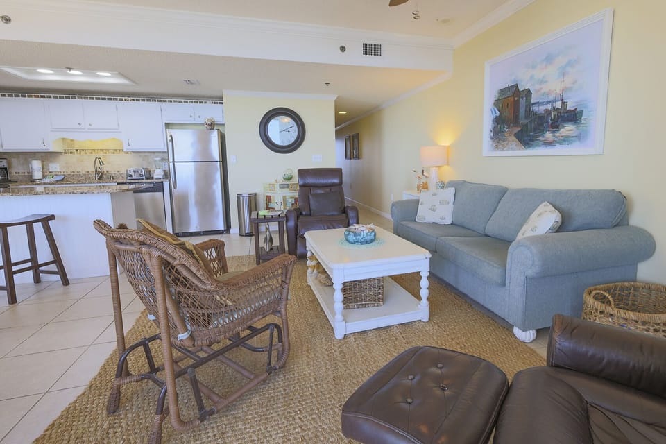 Cozy living area features a blue sofa with queen sleeper and additional comfortable seating with recliners