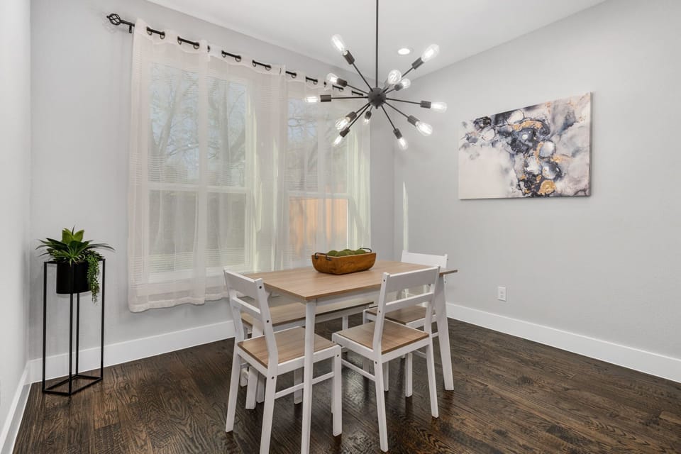 Dining table seats 4 and features a beautiful modern chandelier. 