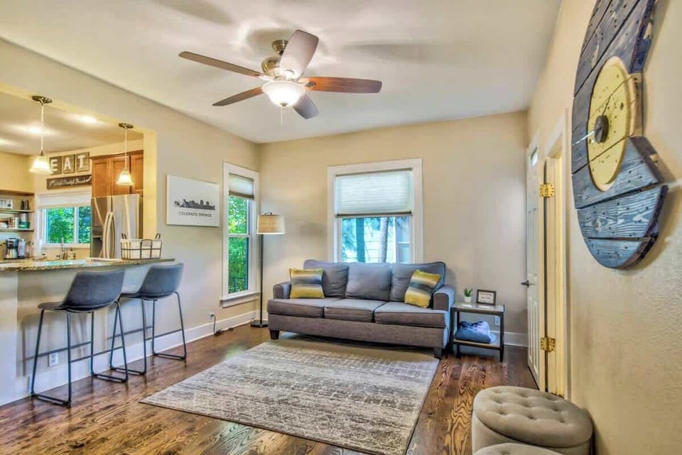 Embrace Comfort and Light! The Living Room Offers Cozy Couches, Bathed in Natural Light from Expansive Windows. Enjoy the Breathtaking Views!