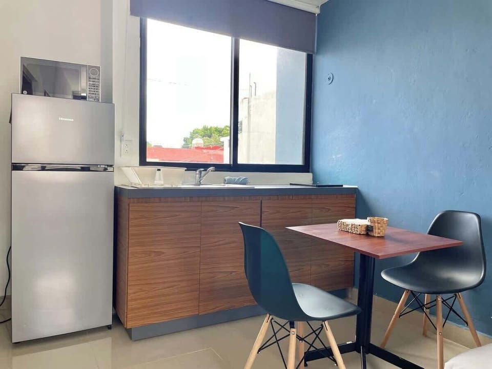 Kitchenette with refrigerator and dining table for two