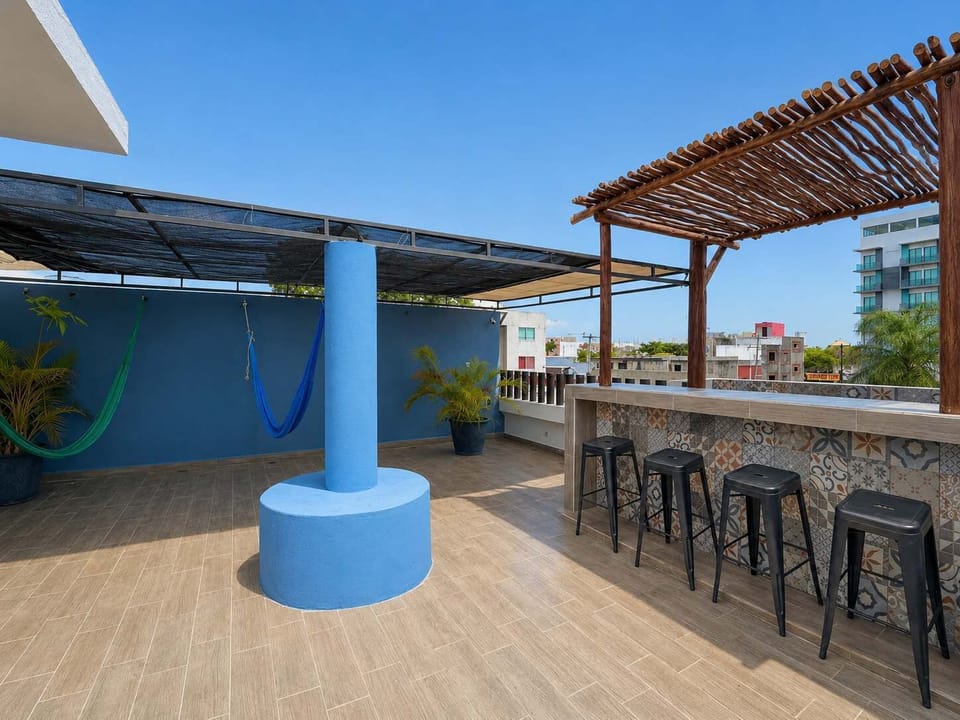 Open rooftop deck with a full bar and stools, a social hangout above the downtown streets