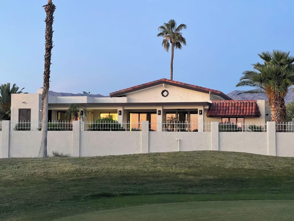 View of the house while standing on the golf course green.
