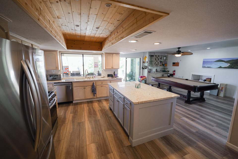 Remodeled kitchen, game room behind the island.
