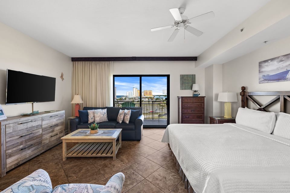 Your bright, versatile space seamlessly blends living and sleeping areas, with sliding doors opening to a private balcony overlooking waterfront views—perfect for enjoying coastal breezes.