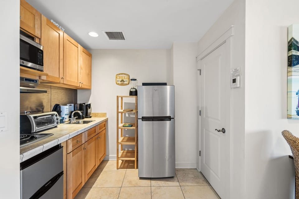 Your fully equipped kitchen awaits with warm wood cabinetry, stainless steel appliances, and everything you need to prepare meals during your stay.