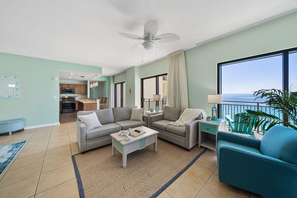 Unwind in your spacious oceanfront living room with plush seating, cooling ceiling fan, and breathtaking sea views.