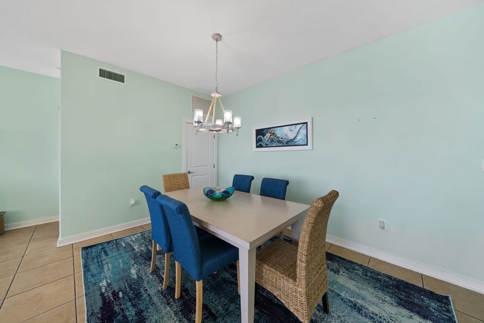 Gather around your stylish dining table where coastal blues meet elegant comfort for memorable meals together.