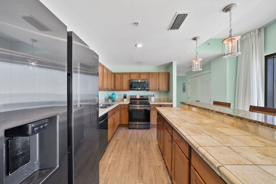 Your fully-equipped kitchen awaits with granite countertops, stainless steel appliances, and warm wood cabinetry for memorable home-cooked meals.