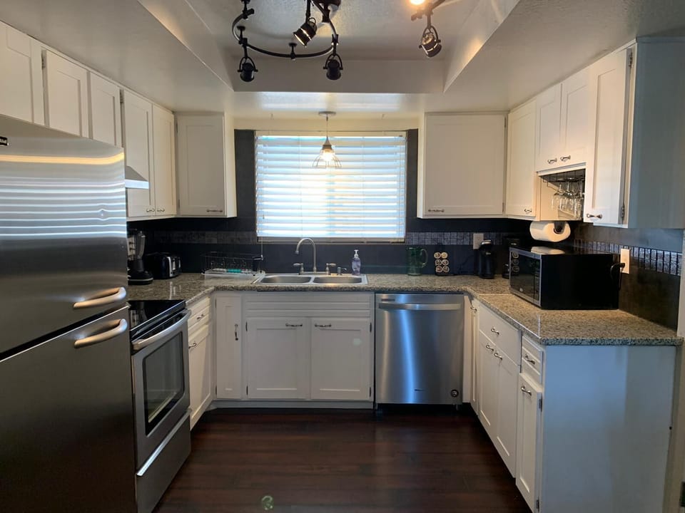 The kitchen with granite counter tops and     new appliances.