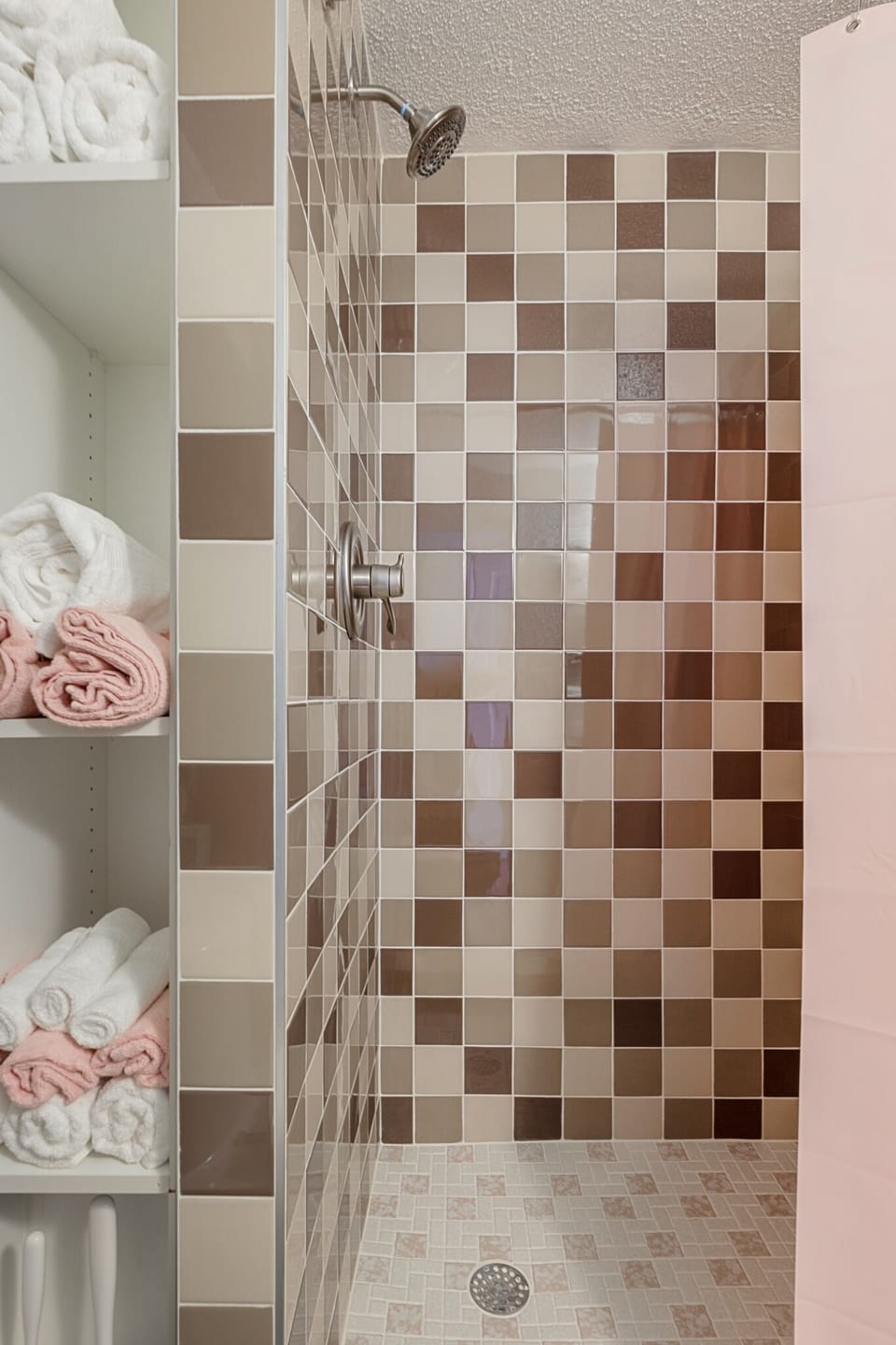 Tiled shower & tub combo w/ modern fixtures for a refreshing start or end to your day.