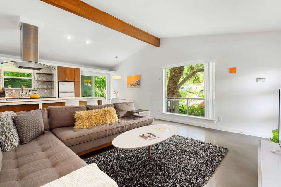 The living room features a comfy sectional sofa and ROKU TV