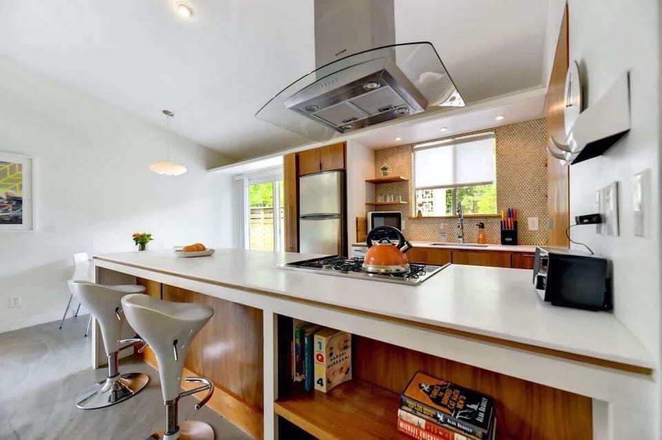 There's seating for 4 at the dining table, 2 at the kitchend island and 4 outside.