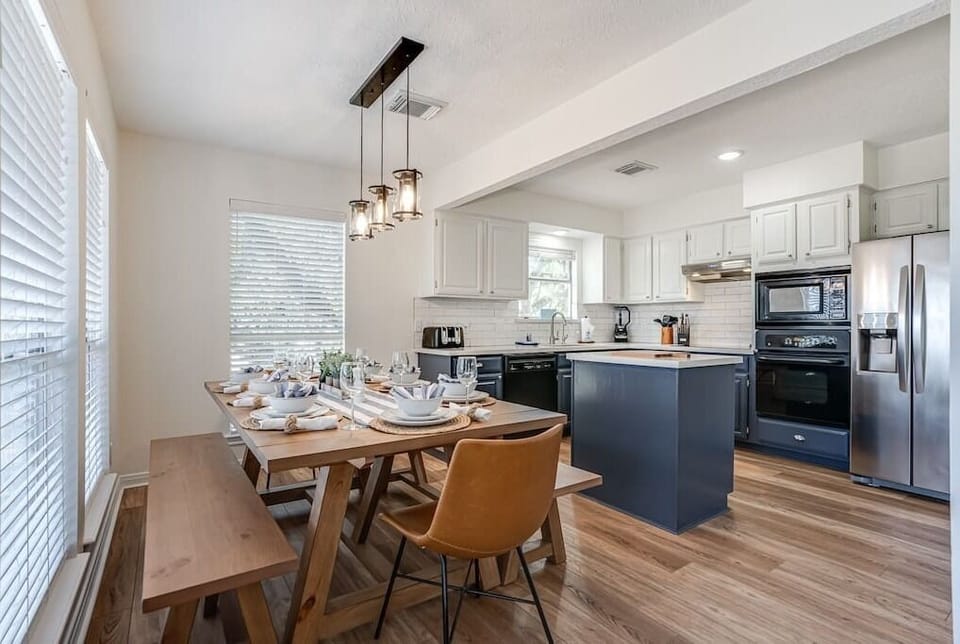 Large dining room table with open kitchen.