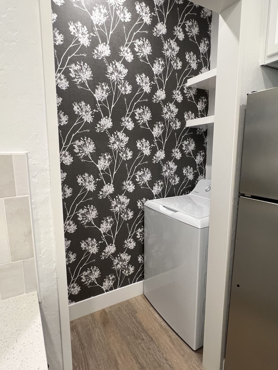Full size washer + dryer next to kitchen.