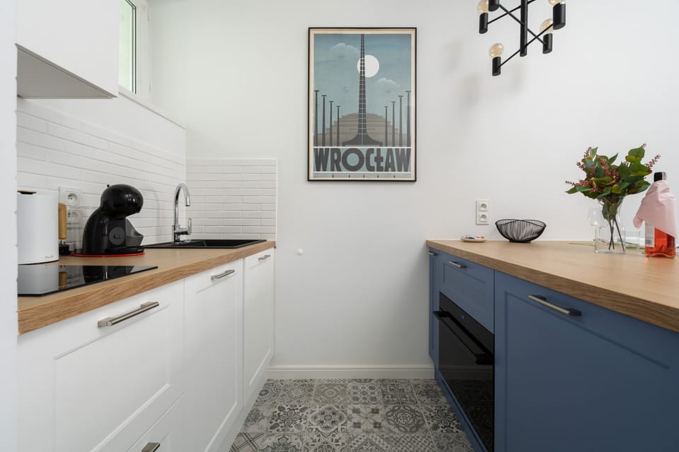 The sleek design of the kitchenette blending seamlessly with the living area.