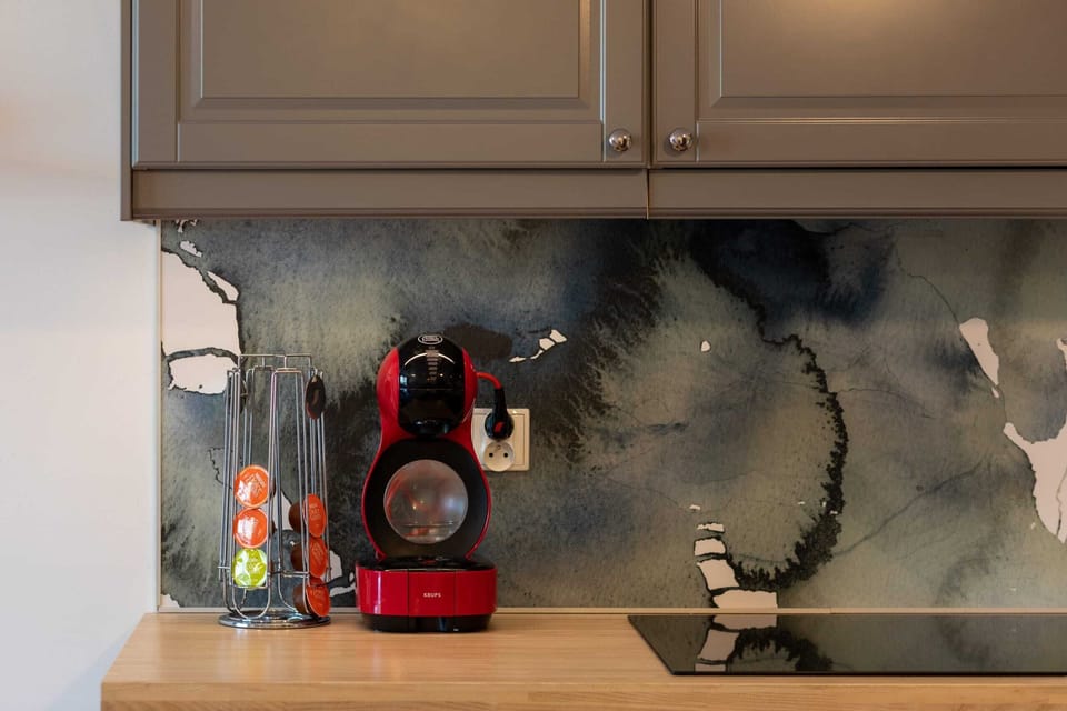  A close-up of the kitchen countertop reveals a stylish, smooth surface with a simple vase and neatly arranged items, creating an organized and appealing space.