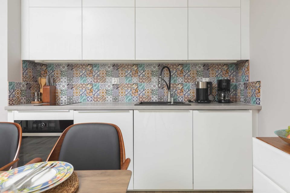 Fully equipped kitchenette with induction hob, oven, fridge, freezer, toaster, coffee machine, electric kettle and dishwasher.