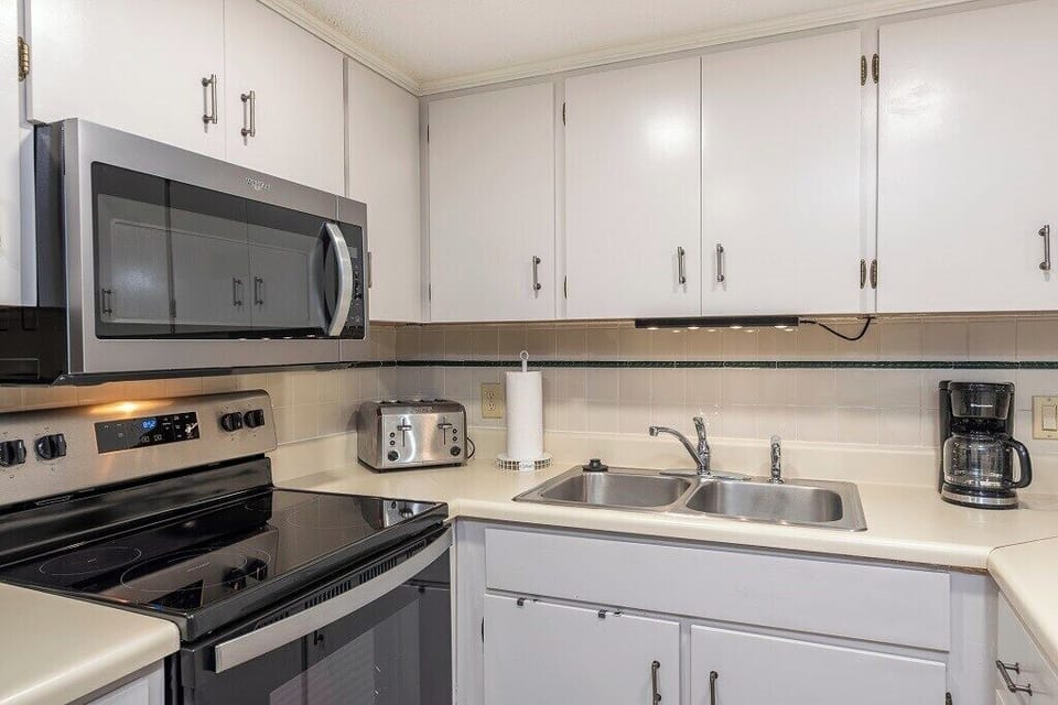 Updated kitchen with modern appliances such as a coffee pot, toaster, microwave, crockpot, and dishwasher!