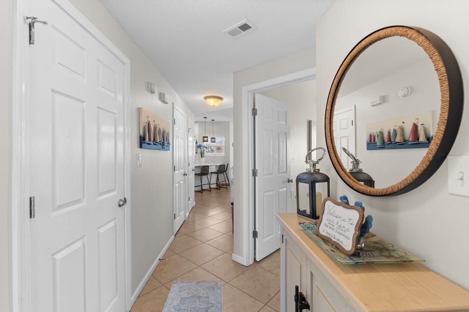 Step into your bright, welcoming entryway where coastal charm greets you with thoughtful touches and a warm message setting the tone for your perfect getaway.