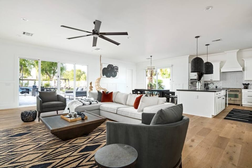 Secluded Comfort: Open Layout Living Room Design, Embraced by Nature's Grandeur
