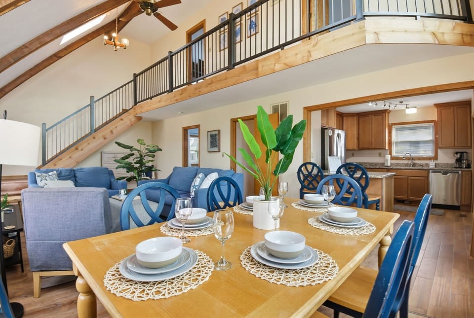 Spacious vaulted great room with loft, full kitchen, and large dining table