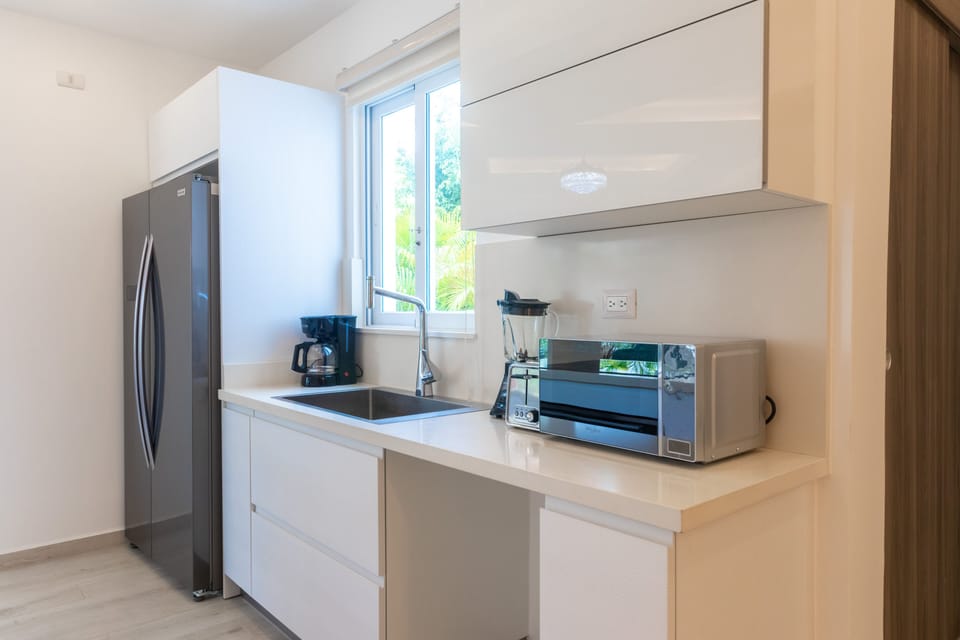 A cozy and modern kitchen with all the necessary utensils