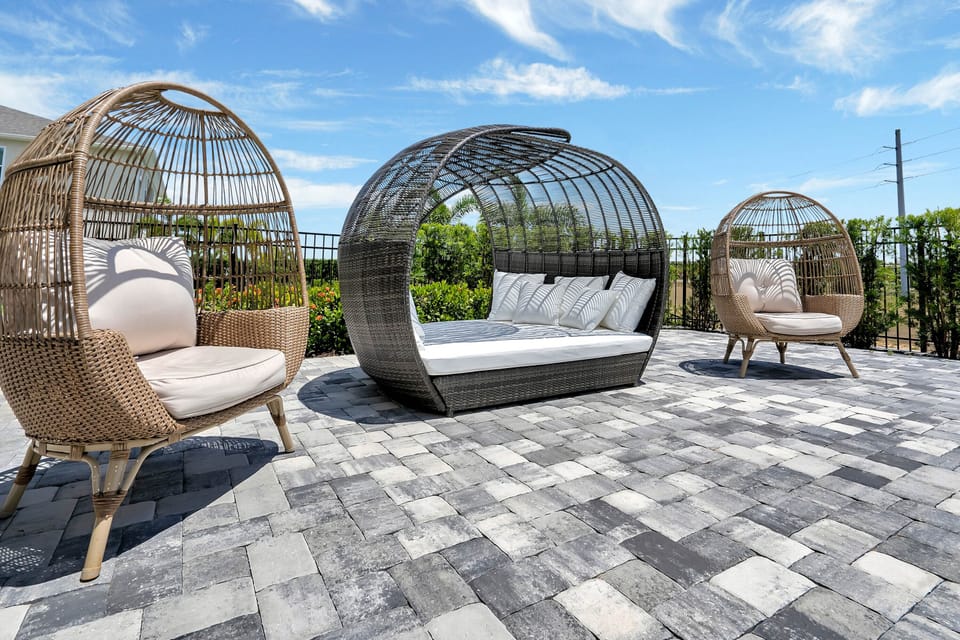 - Sun patio with modern rattan loungers and daybed seating  
- Relax under the open sky in stylish woven egg chairs  
- Perfect poolside lounge setup for guests to unwind