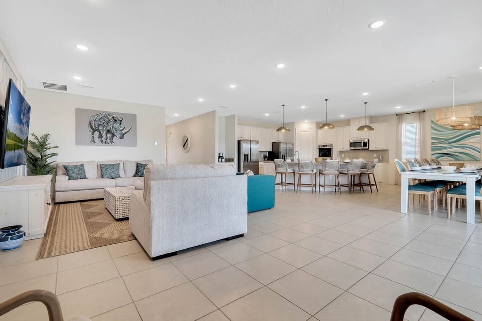 - Bright living room with cozy sectional and TV setup  
- Open floor plan connects kitchen and dining spaces  
- Perfect for family gatherings in a welcoming layout