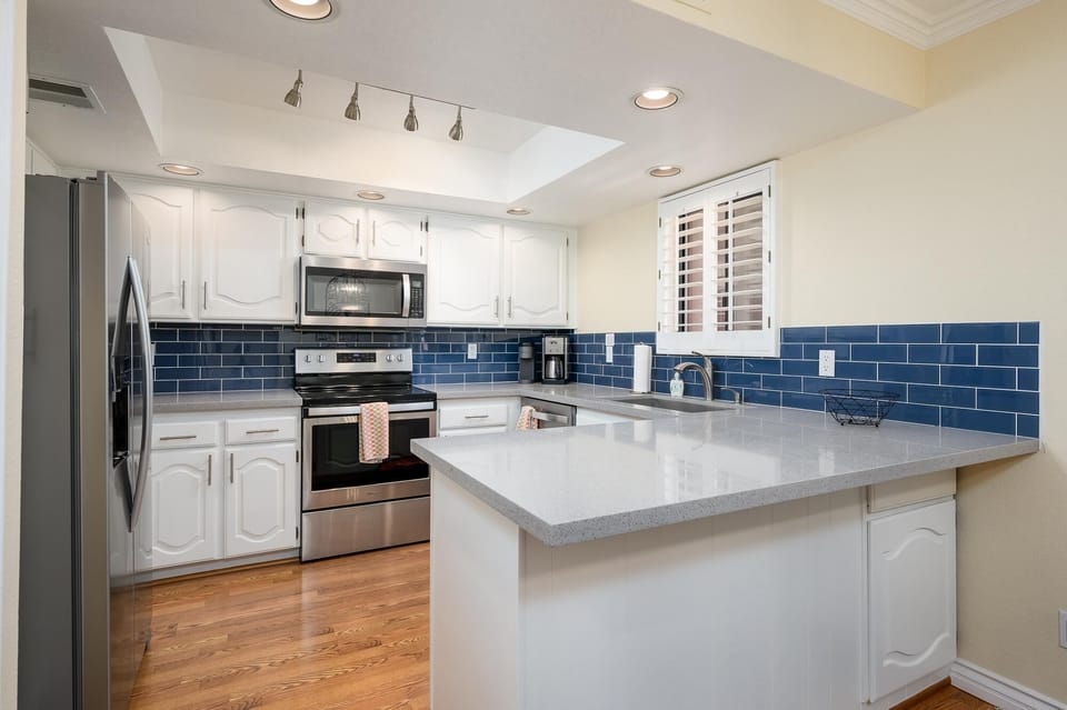 Bright kitchen with granite counter tops.