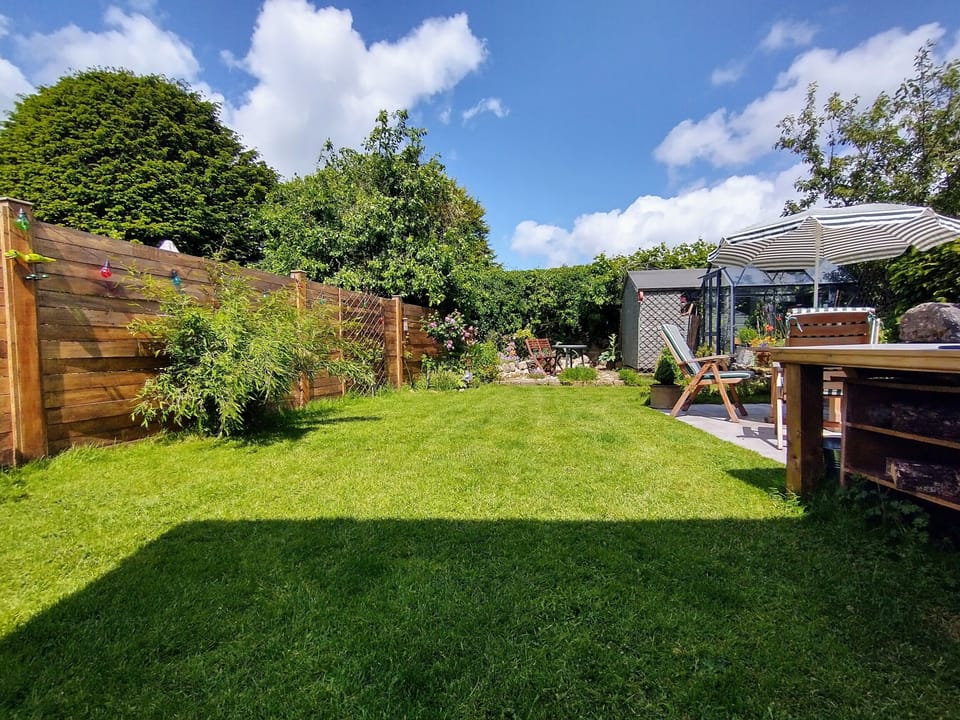Beautiful enclosed and private rear garden with limestone tiled patio