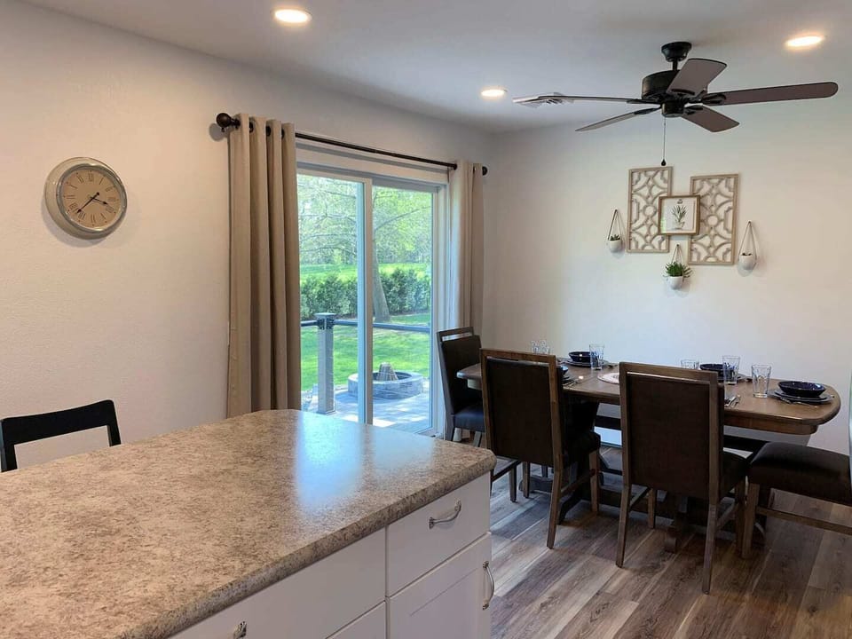 View of dining room and outdoor patio access from kitchen. 