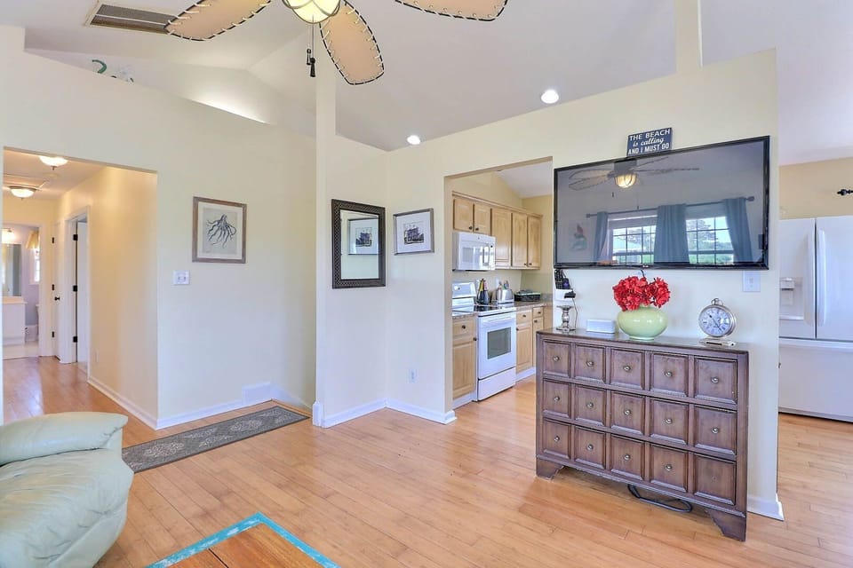 Soak in the bright and airy living space that includes plenty of comfortable furnishings, all centered around a flat-screen TV.