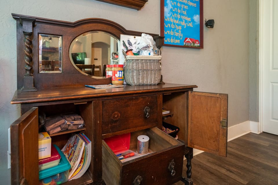 Craft cabinet with coloring, chalk, glue, paper, and bird feeder making activity