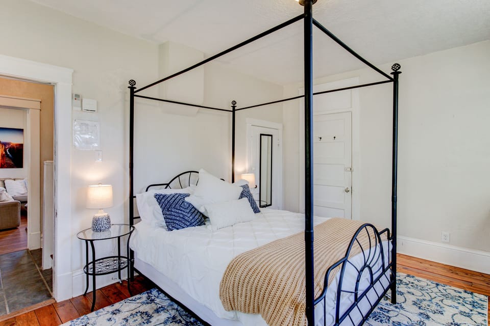Master bedroom with a queen canopy bed