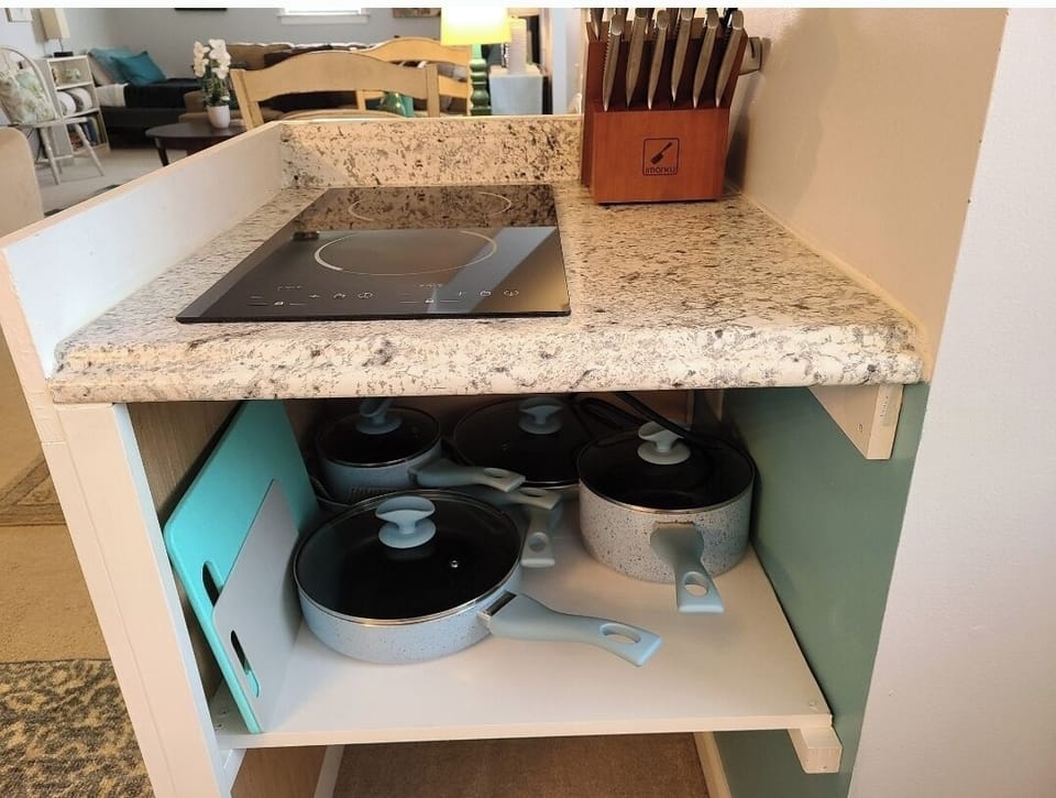 2 burner cooktop, knives, cookware, cutting boards
