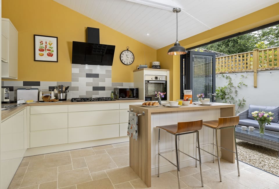 Ground floor: Bi-folding doors extend the kitchen into the pretty courtyard outside