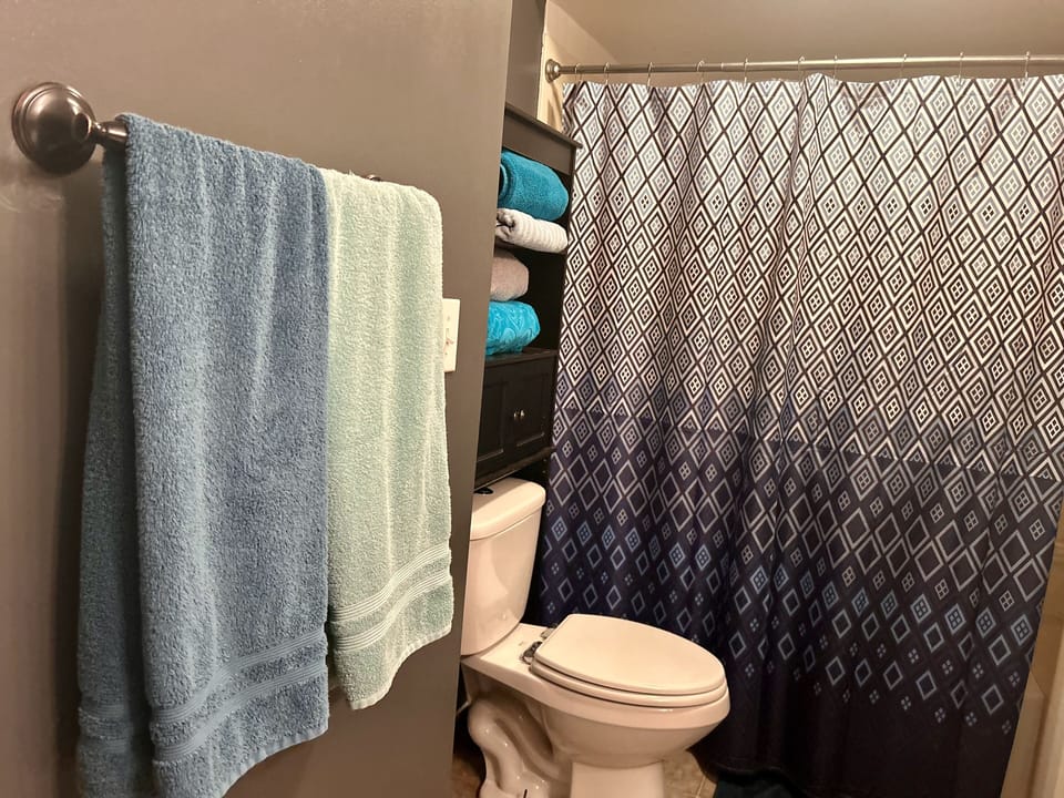Full bath with shower and tub and adjoining laundry room.
