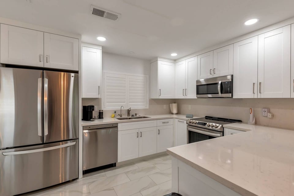 Kitchen with microwave, stove/oven, fridge, dishwasher, traditional coffee maker, utensils etc
