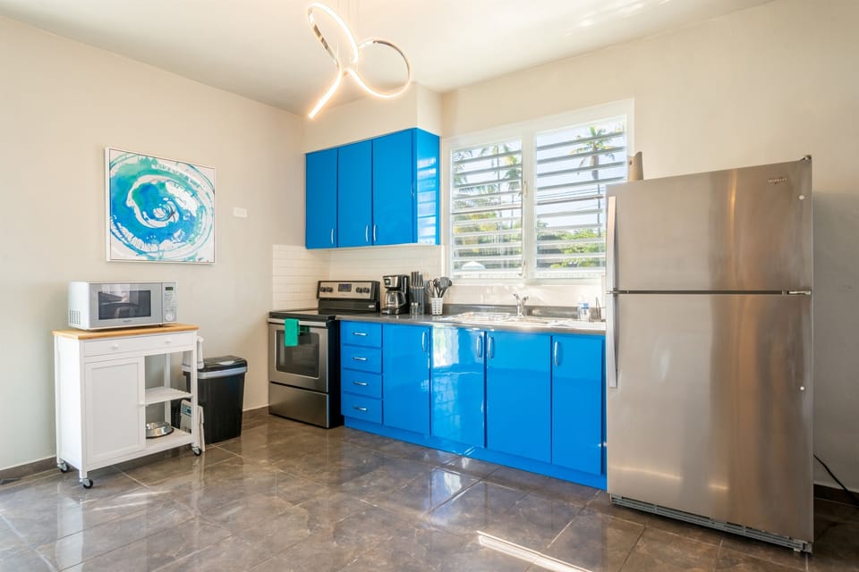 Kitchen: Bright and vibrant space with modern appliances and tropical views! Perfect for culinary adventures!
