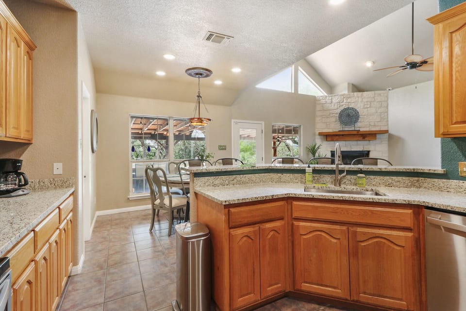Looking over the kitchen bar top to the open concept floorplan.