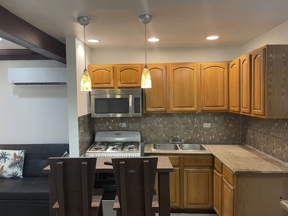 Newly renovated living, dining and kitchen with pool views!