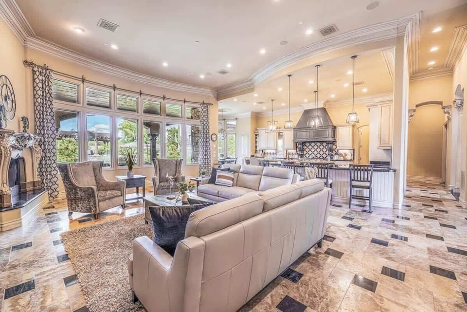 Open living room with soaring ceilings, fireplace, and elegant design for memorable moments.